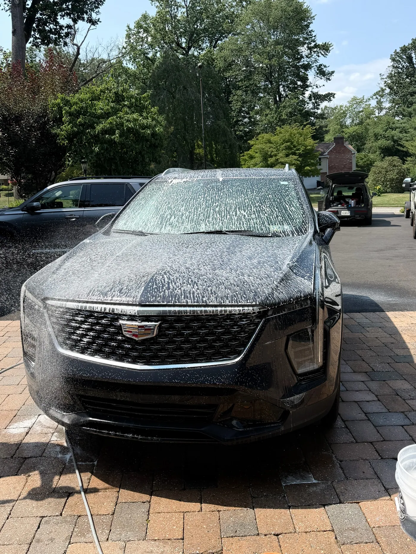 Snow foam covering a car during a hand wash