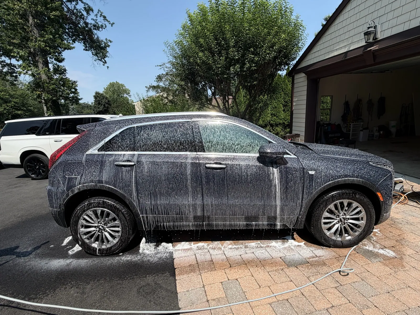Cadillac covered in snow foam during a wash