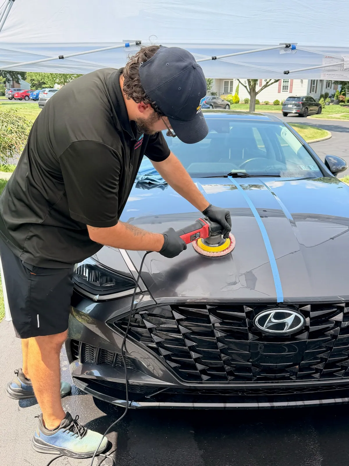 Machine polishing a car's paint to remove swirls